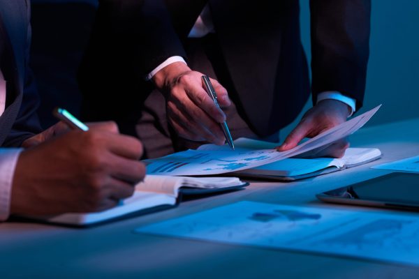 Close-up image of business partners working with financial documents